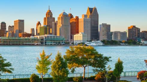 Photo of a river in front of a city skyline.