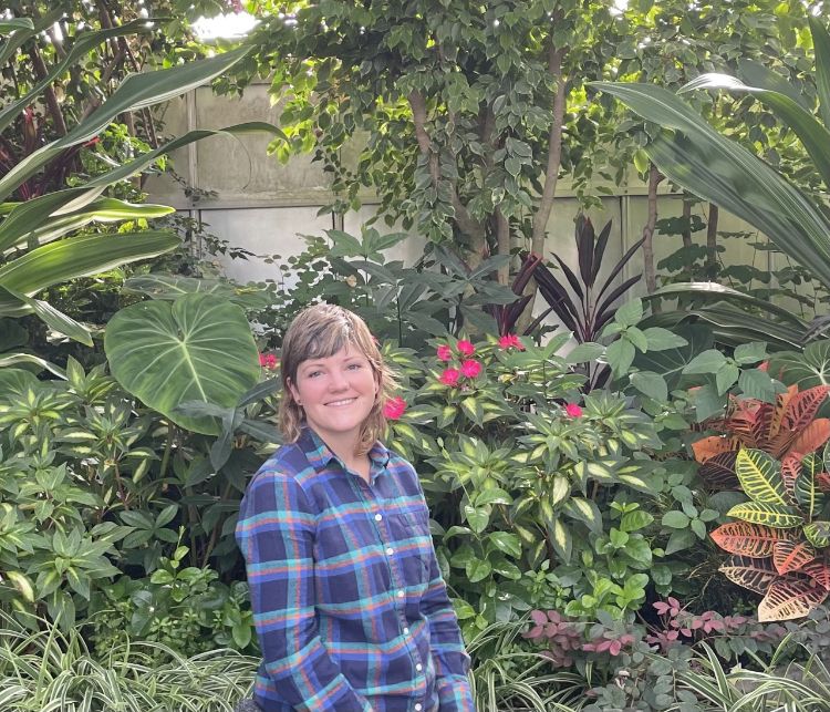 Woman standing in front of flowers