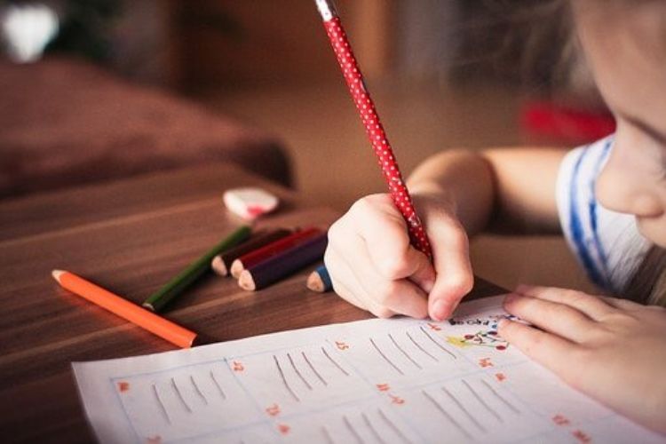 Girl writing on paper