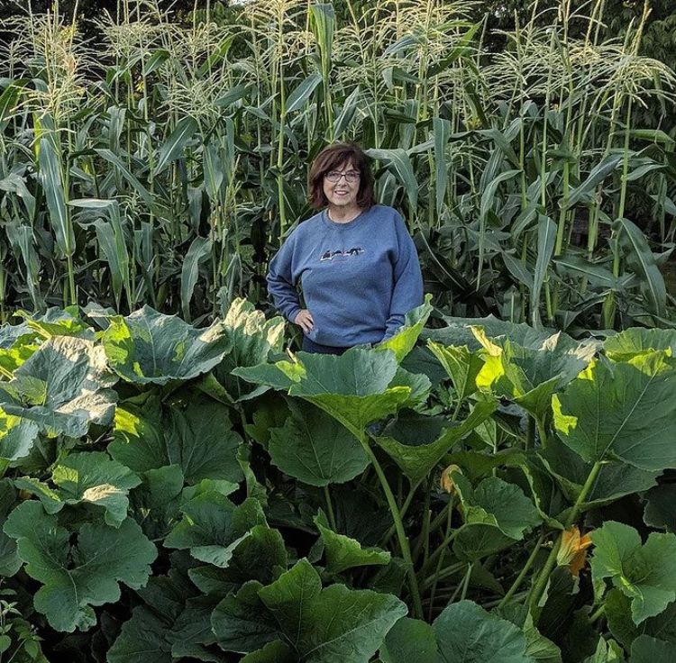 A woman, known as Rozie, standing in a large garden