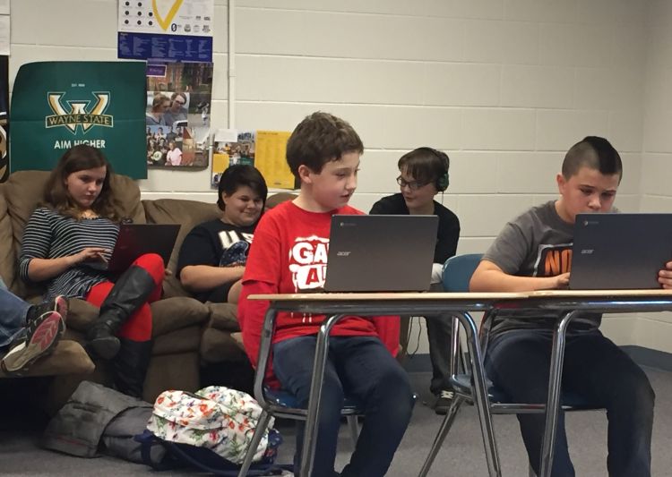 Alcona County youth engaged in computer coding.