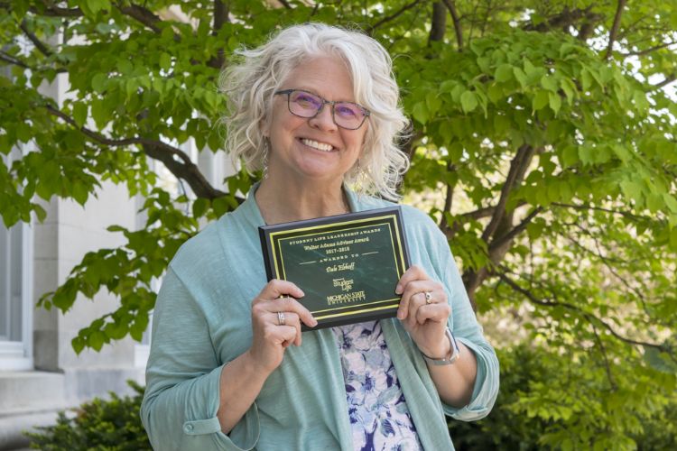 Dale Elshoff with her Advisor of the Year Award outside Agriculture Hall, MSU