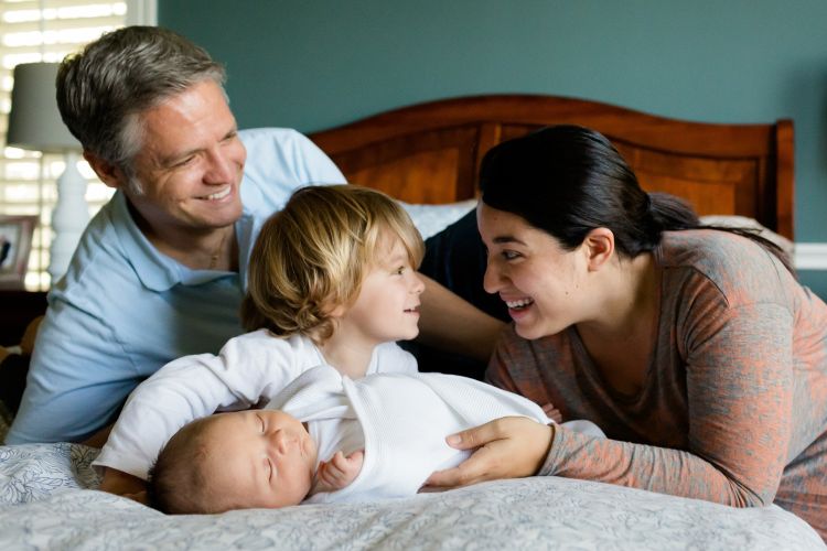 Family on the bed with children