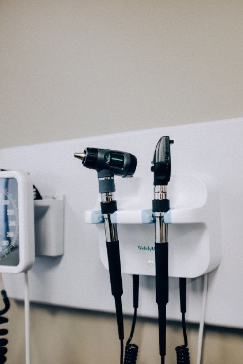 Various medical equipment hanging on a wall at a doctor's office.