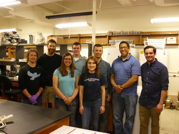 The fish diet study team gathers in the MSU fish research lab, including (back from left) Nick Green, Mark Hamlyn, Nick Yeager, Dr. Dan O’Keefe, Dr, Brian Roth, Brok Lamorandier, (front from left) Katie Kierczynski, Jasmine Czajka. Photo: Katelyn Brolick