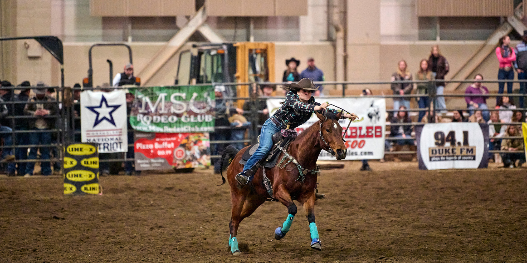 Image of a rodeo performer doing a barrel race.