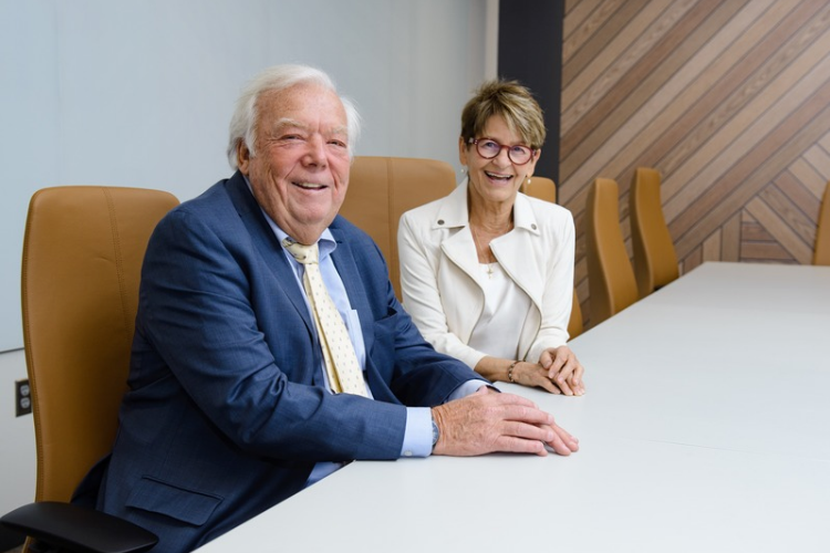 Bill and Mary Lou Somerville sitting in the Somerville Conference Room in the SoP building.