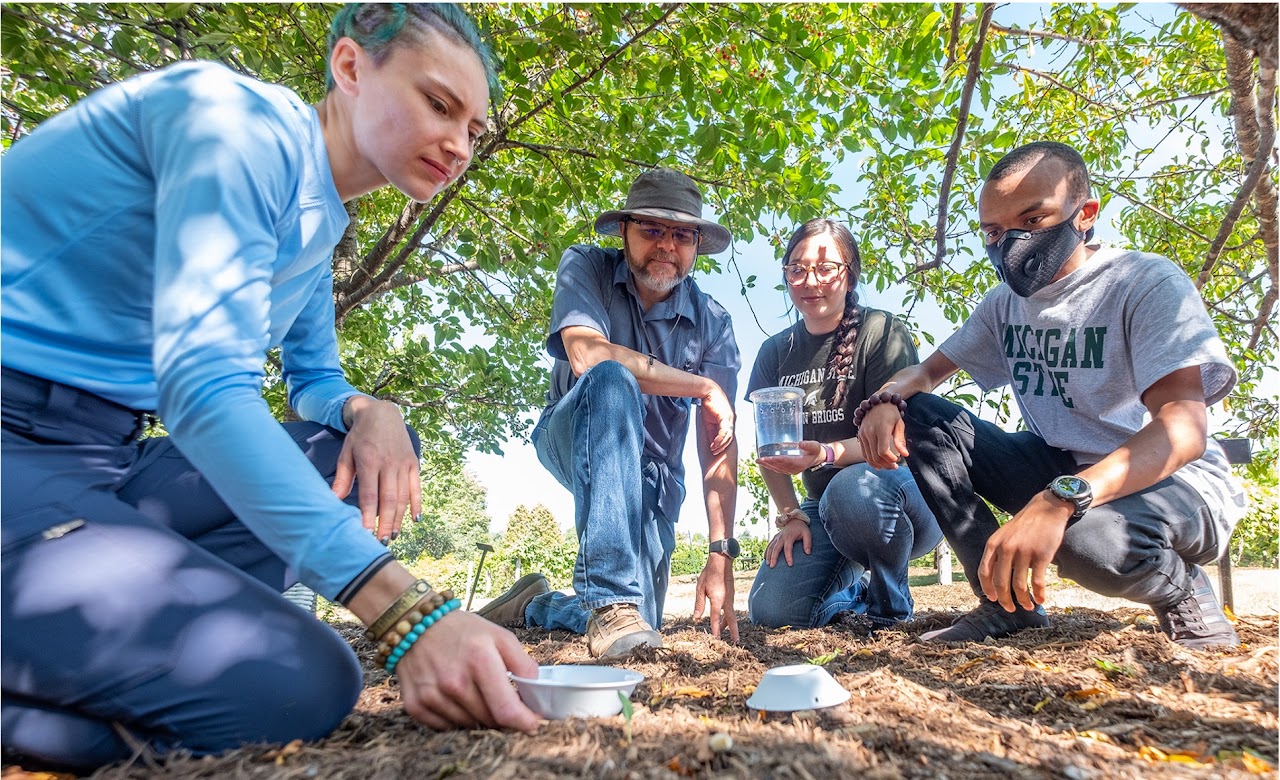 Group of people making observations outdoors