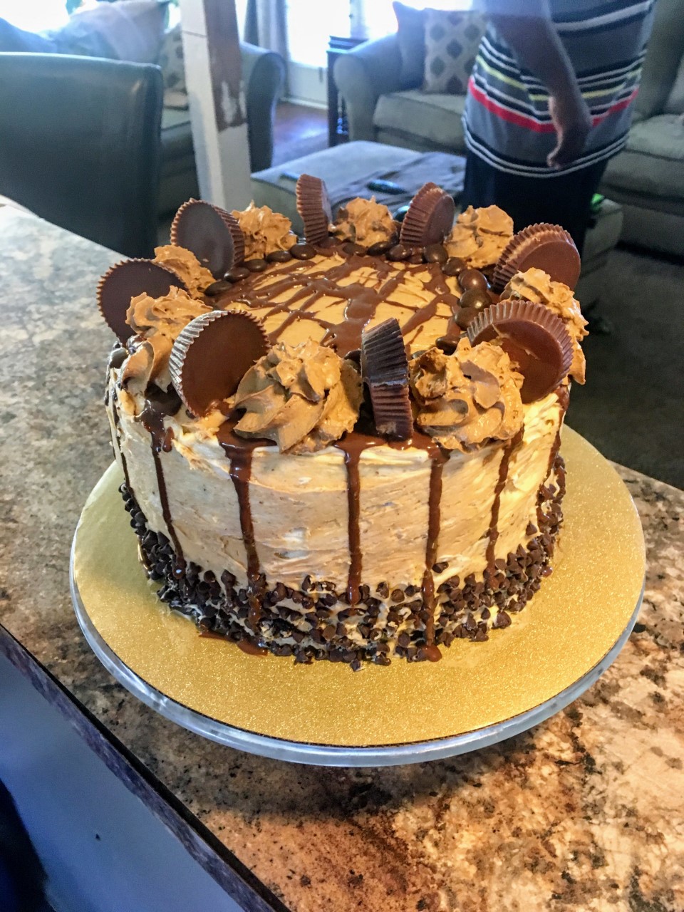 Chocolate cake with A peanut butter buttercream frosting with Reese’s peanut butter cups and chocolate drizzle