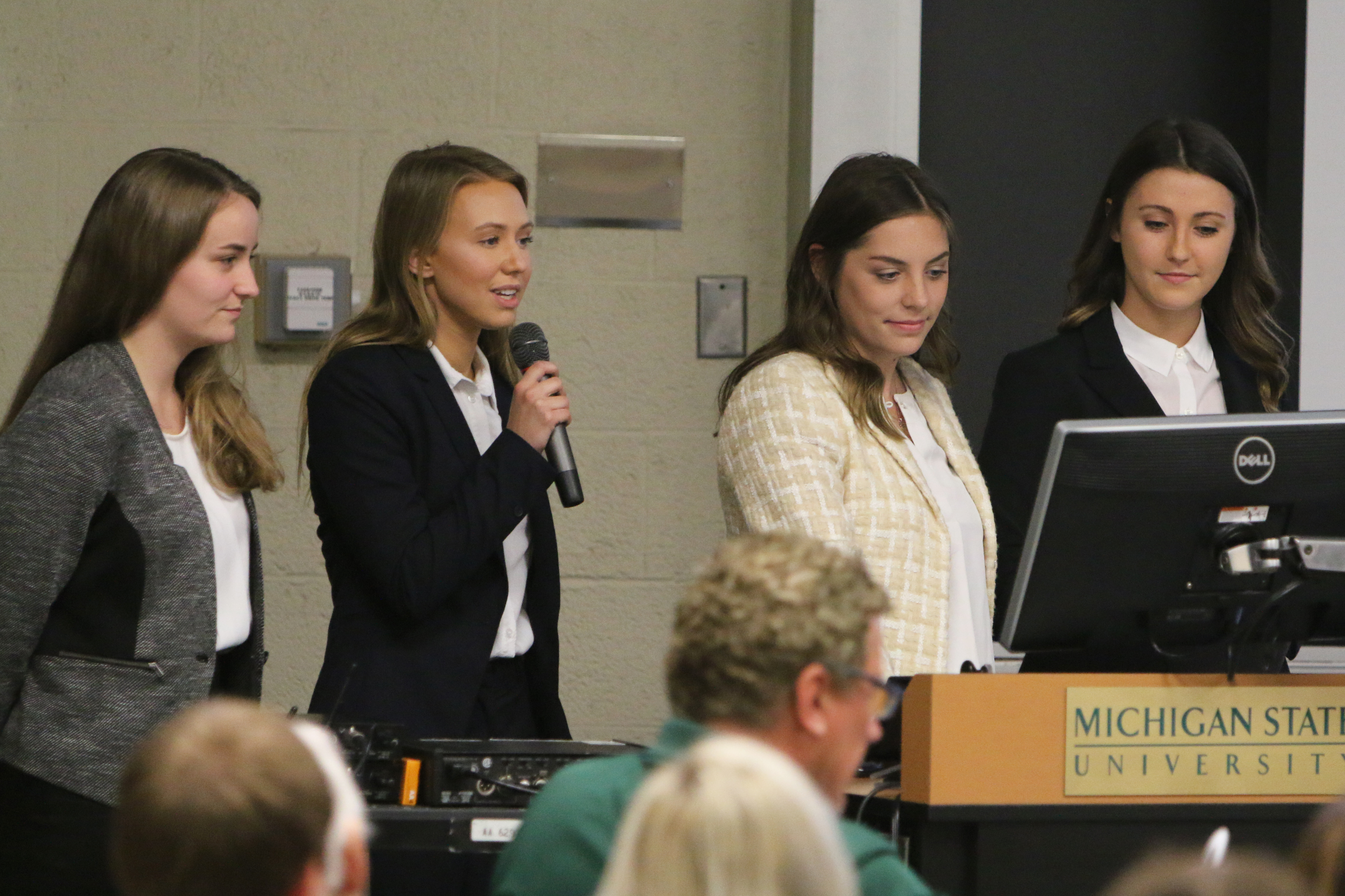 Group of women college studentsgiving a presentation